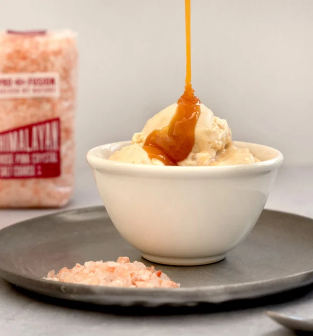 Beat the heat with this delicious salted caramel coconut ice cream, made even better with our Himalayan Pink Salt! 🍦🥥 

For the ice cream:
🍦200 g Sweetened condensed coconut milk 
🍦400 ml coconut whipping cream (refrigerate can overnight)
🍦1 tsp vanilla extract

For the caramel sauce:
🍦1 – 2 tsp Profusion Organic Himalayan Rose Pink Salt (Coarse)
🍦1 can coconut milk (400 ml)
🍦150 g soft light brown sugar
🍦1 tsp vanilla bean paste

For the caramel sauce, place the coconut milk (including water), sugar and vanilla in a pan. Bring to a gentle boil and stir frequently for 20 – 25 minutes. 

After this time, the sauce will have thickened and will be a dark caramel colour. Take it off the heat and stir in the salt. The sauce will still be a little runny but will thicken to the desired consistency as it cools. 

Add the sweetened condensed coconut milk, coconut whipping cream and vanilla extract to a large bowl and whip by hand or on medium strength using an electric whisk for 5 minutes, until it resembles lightly whipped cream.

Spoon in some of the coconut salted caramel sauce, leaving some for later, and fold it through the mixture using a spatula.

Transfer the ice-cream mixture to a loaf pan and cover the tin with more parchment paper so that the ice-cream isn’t exposed to the air.

Place in the freezer to set for 6 hours.

Serve with more coconut salted caramel sauce. 🤤🤤🤤